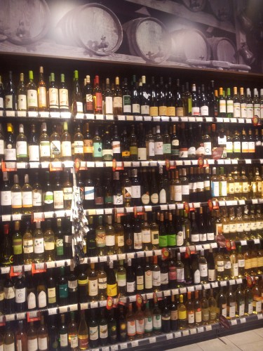 Wine bottles stacked in the supermarket next to St Stephen's Basilica
