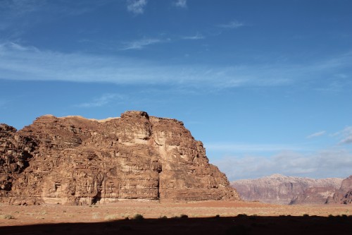 Waking up to a spectacularly blue sky in Wadi Rum...the shadow of the mountains lingering over me.